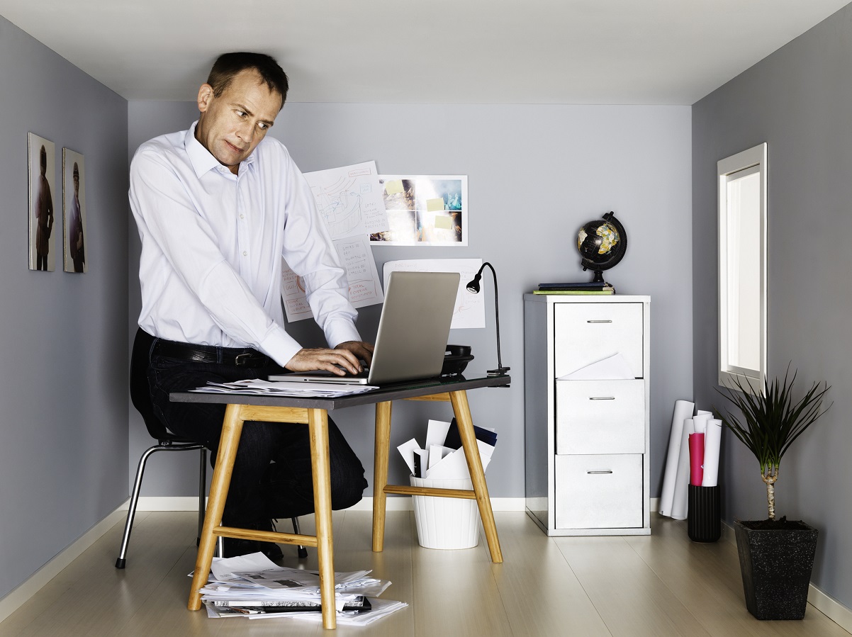 Businessman working in small room